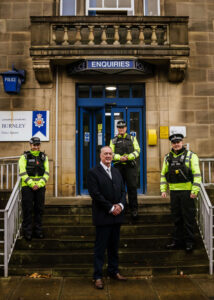 Commissioner Grunshaw and officers outside police station